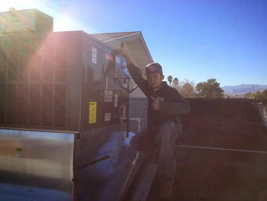 HVAC technician performing HVAC Inspection on a rooftop unit in Liberty Hill